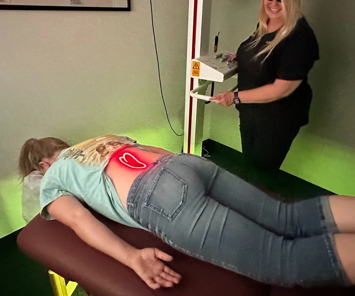 Cold laser therapy applied to a patient's lower back at Back in Action Chiropractic in Las Vegas