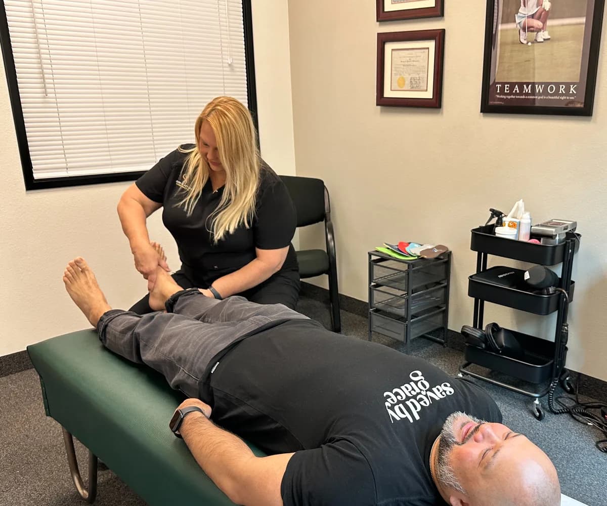 Dr. Michelle Binkowski performing a leg and knee mobilization at Back in Action Chiropractic in Las Vegas