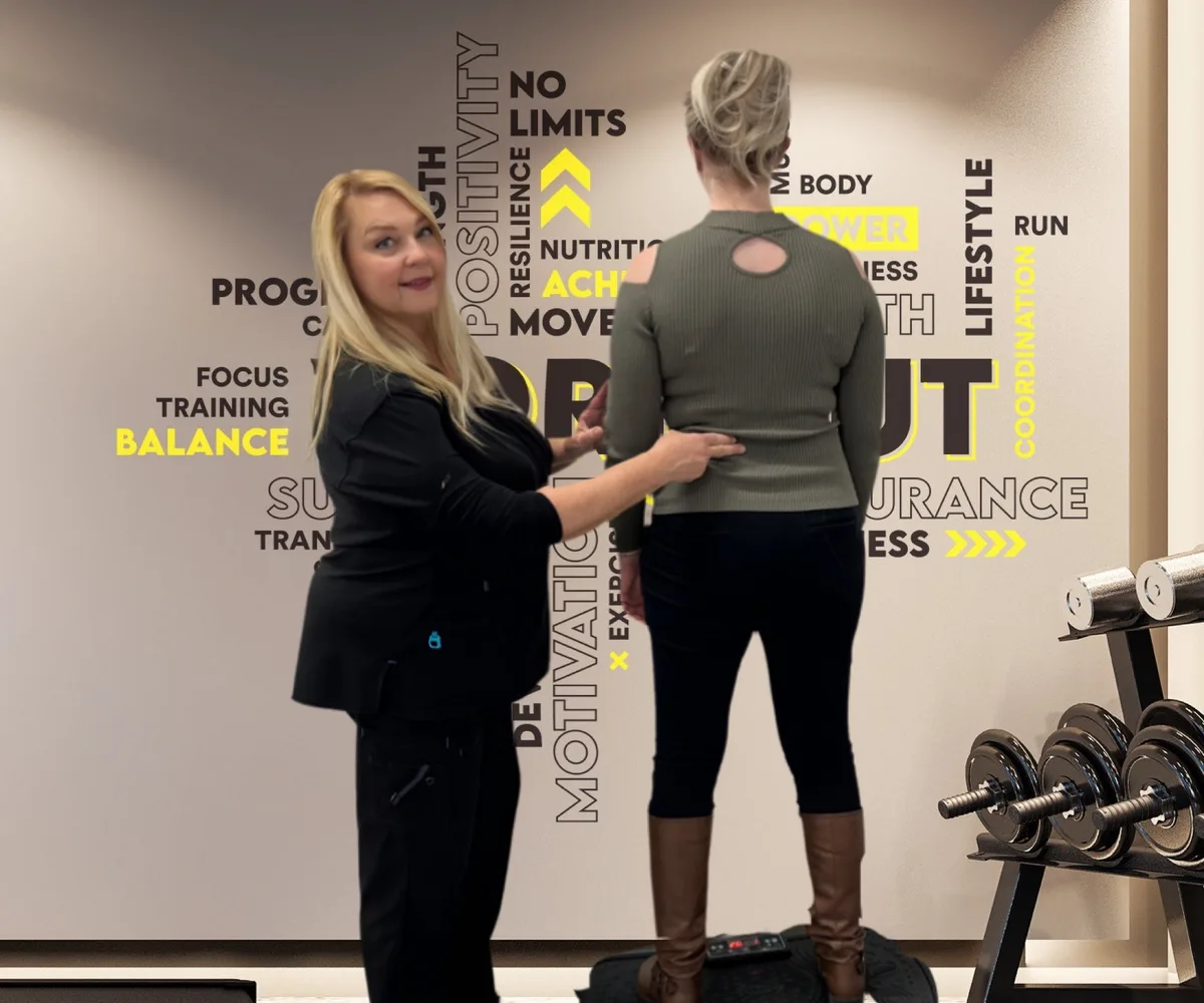 Dr. Michelle Binkowski assessing a patient's spinal posture at Back in Action Chiropractic in Las Vegas