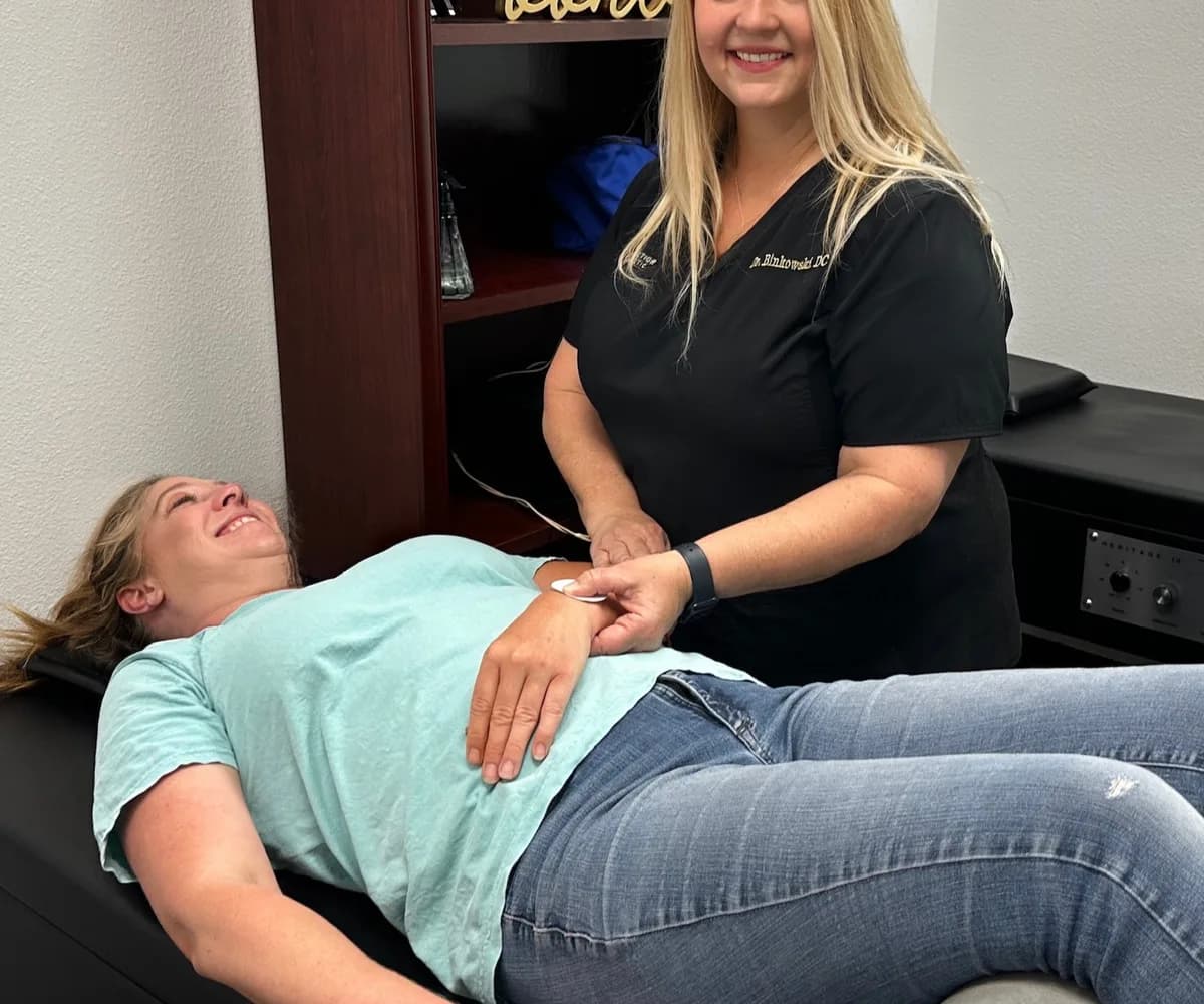 Dr. Michelle Binkowski treating a patient's neck and shoulder for whiplash injury in Las Vegas