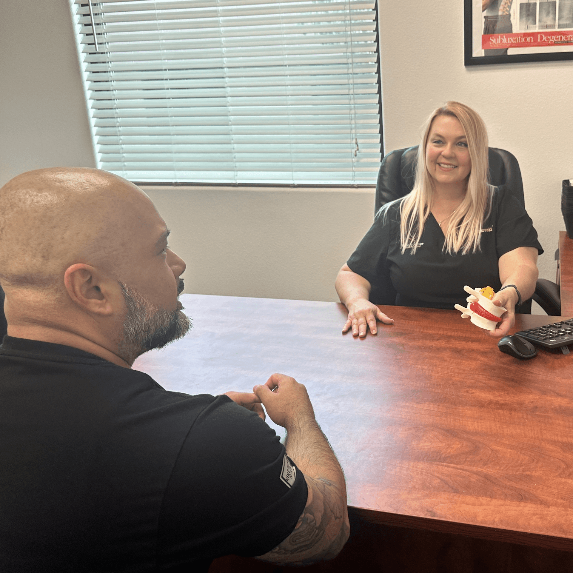 Dr. Binkowski consulting with a patient at Back in Action Chiropractic Las Vegas