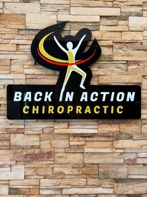 Back in Action Chiropractic logo on the office wall
