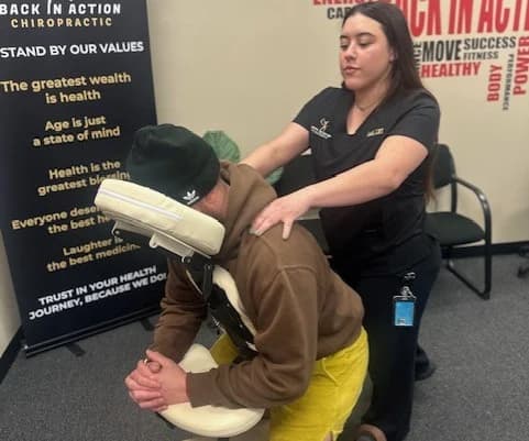 Licensed massage therapist performing a seated chair massage at Back in Action Chiropractic in Las Vegas