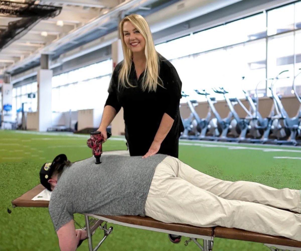 Dr. Michelle Binkowski treating an athlete on a treatment table at a Las Vegas training facility
