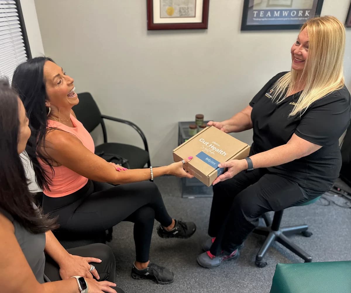 Dr. Michelle Binkowski reviewing a nutritional wellness product with a patient at Back in Action Chiropractic in Las Vegas