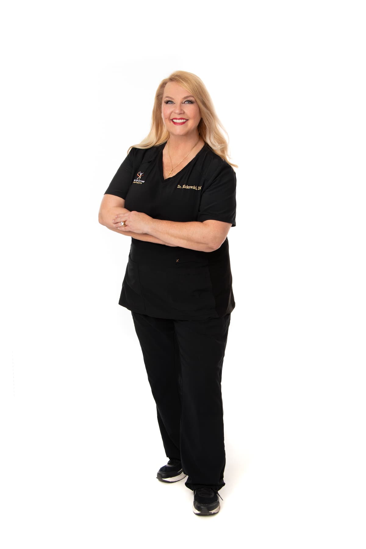 Dr. Michelle Binkowski, Las Vegas chiropractor, full-body portrait in branded scrubs